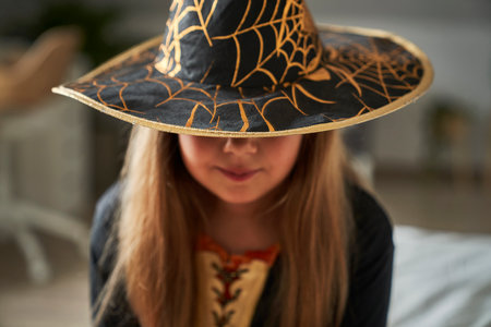 Unrecognizable elementary age girl wearing witch costumeの写真素材