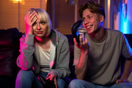 Caucasian couple playing video game with game padsの写真素材