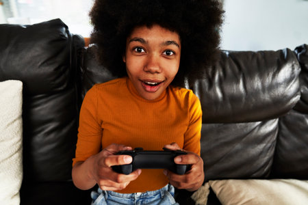 Teenage girl playing video game in the living room