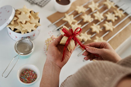 Unrecognizable woman preparing little gifts made of gingerbread cookiesの写真素材