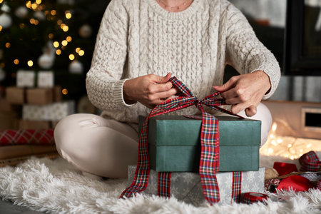 Unrecognizable woman packing presents for Christmasの写真素材