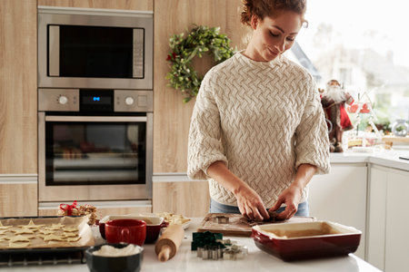 Red head woman preparing dough for the Christmas cookiesの写真素材