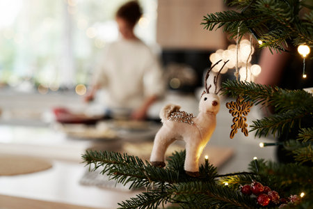 Christmas tree with decorations and woman in the backgroundの写真素材