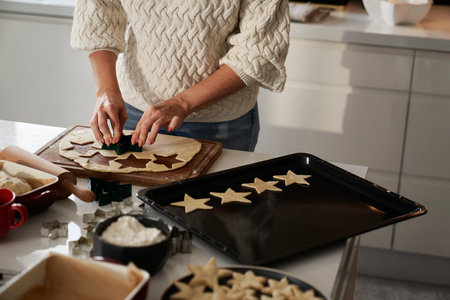 Unrecognizable woman preparing dough for gingerbread cookiesの写真素材