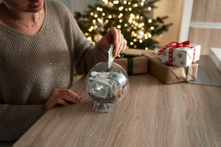 Caucasian woman saving money for Christmas presentsの写真素材