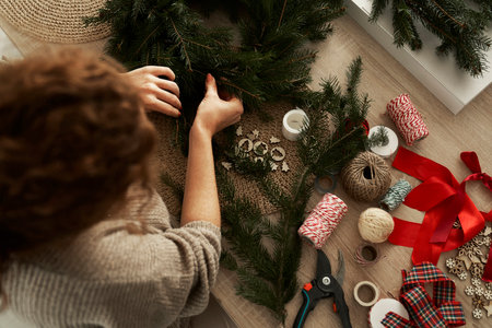 Young caucasian woman making a Christmas wreathの写真素材