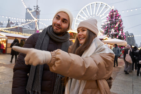 Caucasian couple having fun on Christmas marketの写真素材