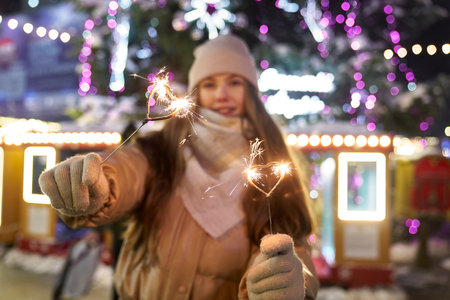 Caucasian couple with sparklers during New Years's party outdoorsの写真素材