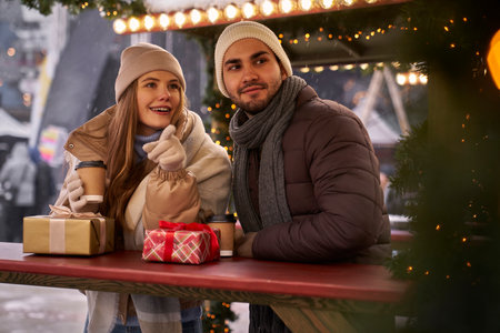 Caucasian couple having fun on Christmas marketの写真素材