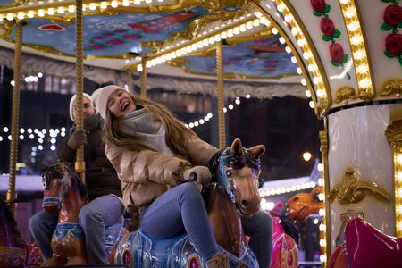 Couple having fun on the carouselの写真素材