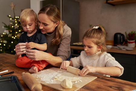 Woman and her children baking Christmas cookiesの写真素材