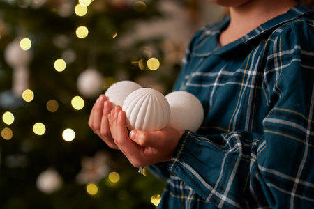 Unrecognizable girl holding three Christmas ballsの写真素材