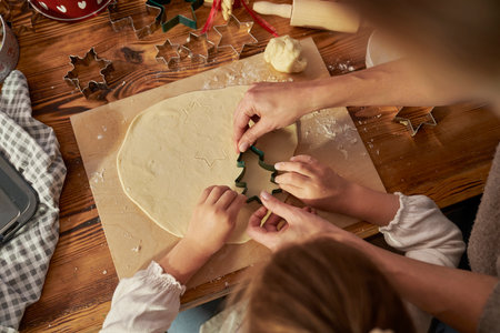 Caucasian woman with daughter making cookies in Christmas time in the kitchenの写真素材