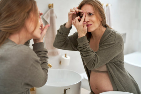 Caucasian pregnant having skin problems during pregnancyの写真素材