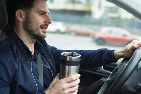 Man using reusable mug in the carの写真素材