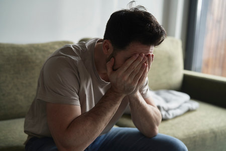 Broken man at home on sofaの写真素材
