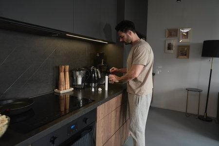 Man putting calcium in the glass with waterの写真素材