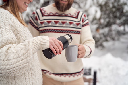 Caucasian couple drinking hot tea in winter timeの写真素材