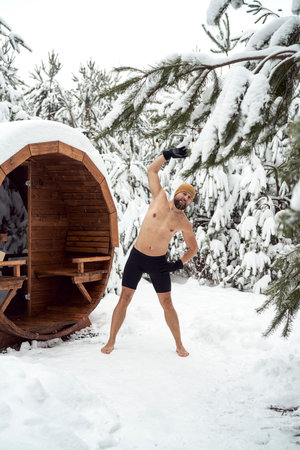 Caucasian man warming up before winter swim in barrelの写真素材