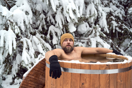 Caucasian man take the winter bath in tube outdoorsの写真素材