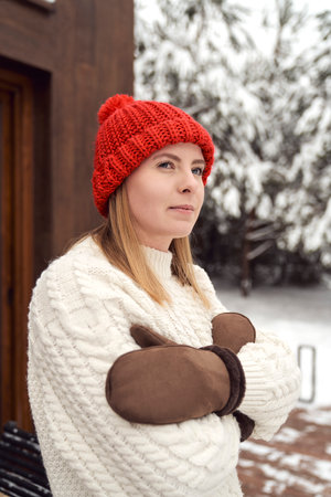 Caucasian woman standing outdoors in winter and warming upの写真素材