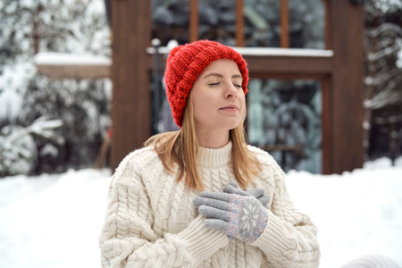 Adult caucasian woman breathing fresh air in winter timeの写真素材