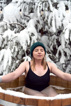 Close up of caucasian woman during the winter bath in tube outdoorsの写真素材