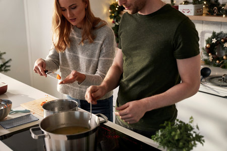 High angle view of caucasian couple cooking together before Christmas in domestic kitchen