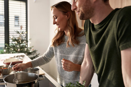 Caucasian couple cooking together before Christmas in domestic kitchenの写真素材