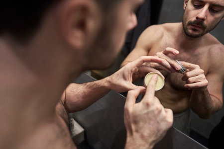 Man using beauty product for his beard
