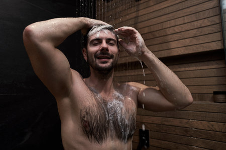 Caucasian man taking shower at home