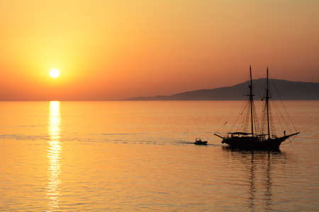 Sunset over the Aegean sea with boatの写真素材