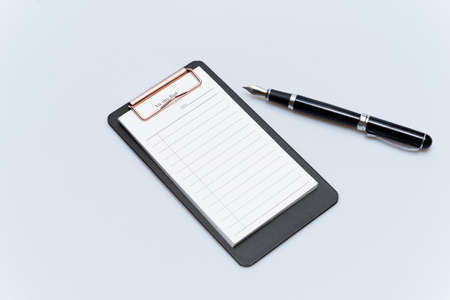 To-do list and fountain pen on a white backgroundの写真素材
