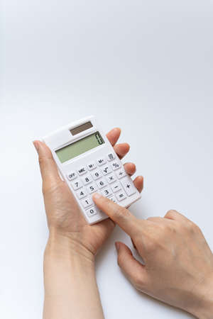 Concept of using calculator on white backgroundの写真素材