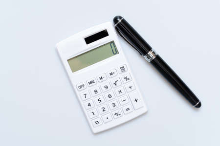Concept of using calculator on white backgroundの写真素材