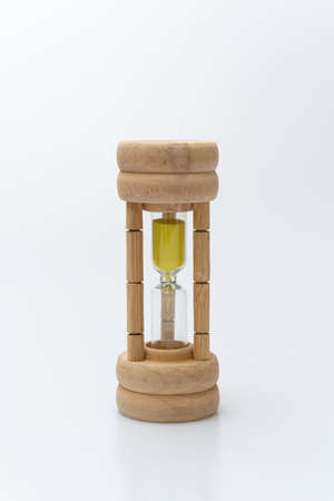 Hourglass held by an Asian on a white backgroundの写真素材