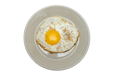 Half-boiled fried egg in a bowlの写真素材