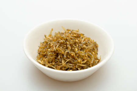 Savory stir-fried anchovies in a bowlの写真素材