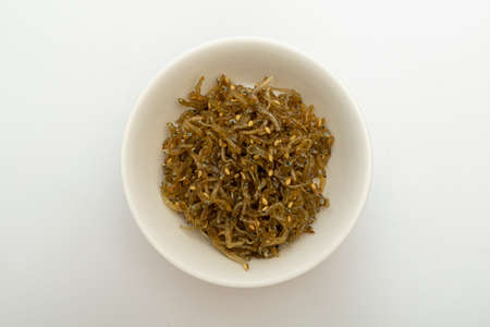 Savory stir-fried anchovies in a bowlの写真素材