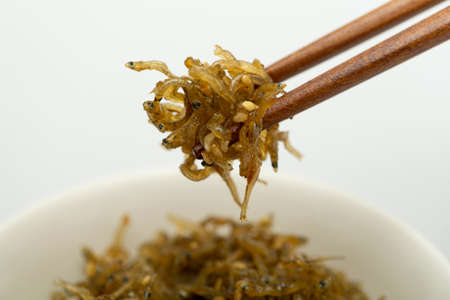 Savory stir-fried anchovies in a bowlの写真素材