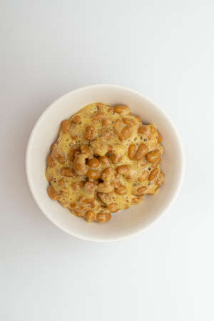 Delicious looking natto in a bowl on a white backgroundの写真素材