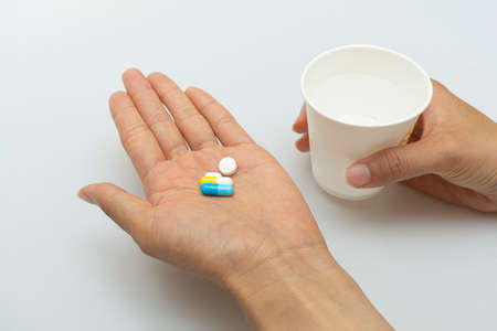 Concept on the palm of the hand for taking various pillsの写真素材