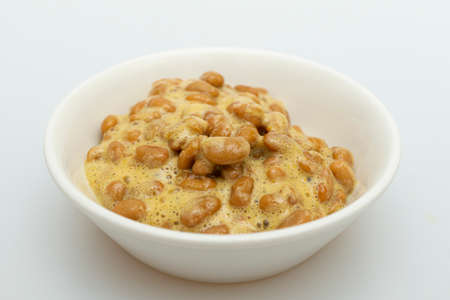 Delicious looking natto in a bowl on a white backgroundの写真素材