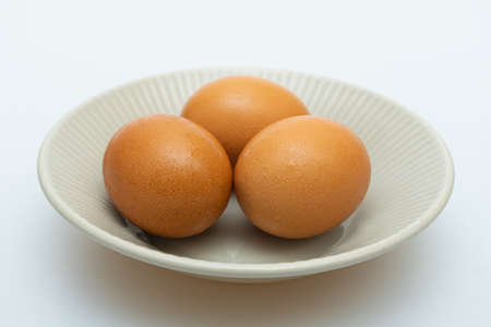 Fresh raw eggs in a bowl conceptの写真素材