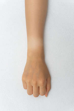 Watch marks on a woman's hand burned in the sunの写真素材