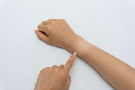 Watch marks on a woman's hand burned in the sunの写真素材