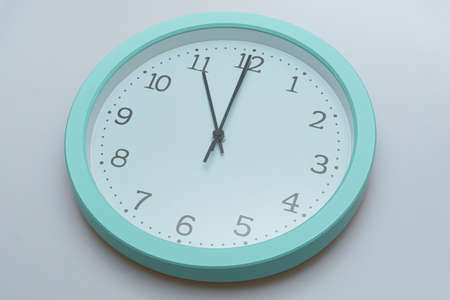 Wall clock showing various times on a white backgroundの写真素材