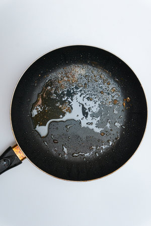 Old frying pan with a lot of greaseの写真素材