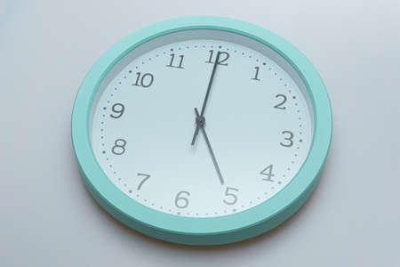 Wall clock showing various times on a white backgroundの写真素材