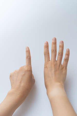 Finger gestures in various actions on a white backgroundの写真素材